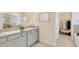 Bright bathroom featuring double vanity with granite countertop and framed mirror at 17142 James Trl, Parrish, FL 34219