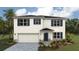 Two-story home features a two-car garage, blue shutters, a covered porch, and professionally landscaped yard at 1750 Cobb Trl, Parrish, FL 34219