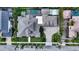 Aerial view of a luxury home showcasing roofline, screened pool, manicured landscaping, and circular driveway at 1910 Datura St, Sarasota, FL 34239