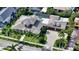 Aerial view of an estate showcasing its tile roof, multiple garage spaces, driveway, and landscaping at 1910 Datura St, Sarasota, FL 34239