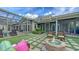 Lush backyard with a cozy fire pit and ample seating, perfect for outdoor gatherings at 1910 Datura St, Sarasota, FL 34239