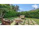 Beautiful backyard featuring a stone fire pit surrounded by comfortable seating, ideal for relaxing and entertaining outdoors at 1910 Datura St, Sarasota, FL 34239