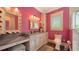 Bright bathroom features a marble countertop, framed mirror, and tiled shower with glass door at 1910 Datura St, Sarasota, FL 34239