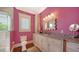 Bright bathroom offers a marble countertop, a framed mirror, and tiled shower with glass door at 1910 Datura St, Sarasota, FL 34239