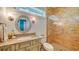 Cozy bathroom with a decorative mirror, elegant vanity, shower with brick-patterned tile, and soft lighting at 1910 Datura St, Sarasota, FL 34239