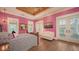 Bright bedroom features high ceilings, a ceiling fan, french doors, and hardwood floors at 1910 Datura St, Sarasota, FL 34239