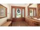 Inviting entryway with wood door, detailed trim, and hardwood floors offers a warm welcome at 1910 Datura St, Sarasota, FL 34239