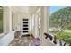 Bright entryway featuring tile flooring, a modern front door, and large windows offering views of lush greenery at 1910 Datura St, Sarasota, FL 34239