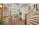 Grand foyer with high ceilings, hardwood floors, and a staircase creates an elegant first impression at 1910 Datura St, Sarasota, FL 34239