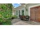 Close up of a side entrance highlighting the lush landscaping and decorative wreath at 1910 Datura St, Sarasota, FL 34239