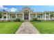 Stunning entrance with a decorative front door, well-manicured lawn, and inviting walkway showcasing the home's curb appeal at 1910 Datura St, Sarasota, FL 34239
