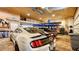 Spacious garage featuring a car lift, wooden ceiling, and ample space for multiple vehicles and storage at 1910 Datura St, Sarasota, FL 34239