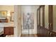 Hallway view featuring linen cabinet, wall art, and convenient access to a well-appointed bathroom with vanity and lighting at 1910 Datura St, Sarasota, FL 34239