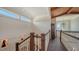 Elegant hallway featuring wooden railings, custom wall decor, and a wooden ceiling, with natural light at 1910 Datura St, Sarasota, FL 34239