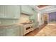 Gourmet kitchen features a professional range, custom cabinetry, and stone countertops at 1910 Datura St, Sarasota, FL 34239