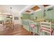 Charming kitchen with light green cabinetry, hardwood floors, and breakfast bar, perfect for casual dining at 1910 Datura St, Sarasota, FL 34239