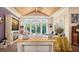 Cozy living room with fireplace, hardwood floors, and pool views through large windows, ideal for relaxation at 1910 Datura St, Sarasota, FL 34239