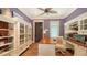 A charming office area with custom built-ins, desk and interesting architectural door at 1910 Datura St, Sarasota, FL 34239