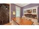 Charming home office with hardwood desk, custom shelving, and window with plantation shutters at 1910 Datura St, Sarasota, FL 34239