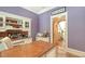 Charming home office with hardwood desk, custom shelving, and an open doorway at 1910 Datura St, Sarasota, FL 34239