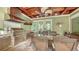 Outdoor kitchen features stainless steel grill, stone accents, overhead fan and covered dining area at 1910 Datura St, Sarasota, FL 34239
