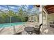 Inviting outdoor pool area with a screened enclosure, comfortable seating, and lush tropical landscaping at 1910 Datura St, Sarasota, FL 34239