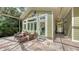 Outdoor seating area on a paved deck with beautiful landscaping and screened enclosure at 1910 Datura St, Sarasota, FL 34239