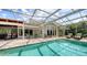 Beautiful screened-in pool area with outdoor dining and lounge seating. Great for relaxing and entertaining at 1910 Datura St, Sarasota, FL 34239