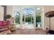 Bright living room, with French doors, showcasing the refreshing pool and outdoor space creating an indoor-outdoor connection at 1910 Datura St, Sarasota, FL 34239