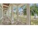 Covered porch with columns offering a relaxing outdoor space with views of the beautifully landscaped neighborhood at 1910 Datura St, Sarasota, FL 34239