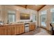 Elegant wet bar with custom wooden cabinetry, granite countertop, and beverage refrigerator at 1910 Datura St, Sarasota, FL 34239