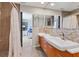 Modern bathroom with double sinks, a glass-enclosed shower, and access to the primary bedroom at 2049 E Leewynn Dr, Sarasota, FL 34240
