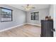 Bedroom with wood floors, closet, and a ceiling fan at 2049 E Leewynn Dr, Sarasota, FL 34240