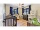 Bedroom featuring wood floors, a crib, and plenty of storage space at 2049 E Leewynn Dr, Sarasota, FL 34240