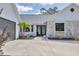 Beautiful home with a gray garage door and an accent of white brick on the front exterior at 2049 E Leewynn Dr, Sarasota, FL 34240