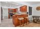 Well-lit kitchen with a breakfast bar, stainless steel appliances, and warm wood cabinetry at 2049 E Leewynn Dr, Sarasota, FL 34240