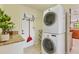 Bright laundry room with granite countertops, stacked washer/dryer, and convenient storage solutions at 2049 E Leewynn Dr, Sarasota, FL 34240