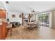 Open-concept living room with fireplace, light wood floors, and sliding glass doors to the outdoor patio at 2049 E Leewynn Dr, Sarasota, FL 34240