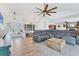 Inviting living room showcases a sectional couch, stylish ceiling fan, and elegant finishes at 2049 E Leewynn Dr, Sarasota, FL 34240