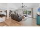 Spacious living room with hardwood floors, a ceiling fan, and sliding glass doors at 2049 E Leewynn Dr, Sarasota, FL 34240
