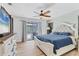 Main bedroom with wood floors, ceiling fan, backyard views, and a large dresser at 2049 E Leewynn Dr, Sarasota, FL 34240