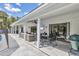 Large covered patio offers comfortable seating, outdoor dining, and seamless indoor-outdoor flow at 2049 E Leewynn Dr, Sarasota, FL 34240