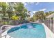 Inviting backyard pool with a diving board and a black fence surrounded by palm trees at 2049 E Leewynn Dr, Sarasota, FL 34240