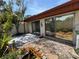 Backyard features rock garden with bromeliads, stone pavers, and shaded patio at 2058 Sunset Point Rd # 11, Clearwater, FL 33765