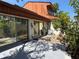 Backyard patio with tropical landscaping and sliding glass doors at 2058 Sunset Point Rd # 11, Clearwater, FL 33765