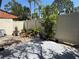 Private backyard oasis featuring a garden with colorful plants and a well-maintained fence at 2058 Sunset Point Rd # 11, Clearwater, FL 33765