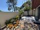 Cozy backyard oasis with decorative stone, plants, and fence at 2058 Sunset Point Rd # 11, Clearwater, FL 33765