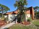 Charming townhouse with desert landscaping and a walkway leading to the front door at 2058 Sunset Point Rd # 11, Clearwater, FL 33765