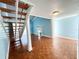 Bright living room with wood floors, fireplace, and staircase to the upper level at 2058 Sunset Point Rd # 11, Clearwater, FL 33765