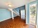 Inviting living room featuring a staircase, wood floors and neutral paint at 2058 Sunset Point Rd # 11, Clearwater, FL 33765